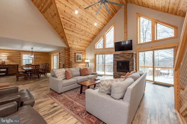 a living room with furniture a fireplace and a large window