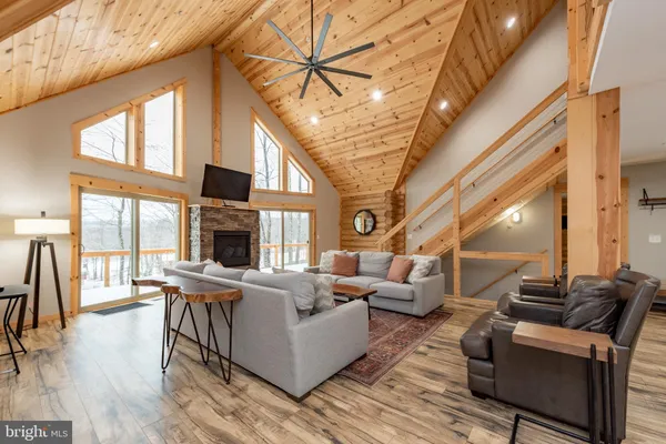 a living room with furniture a fireplace and a chandelier