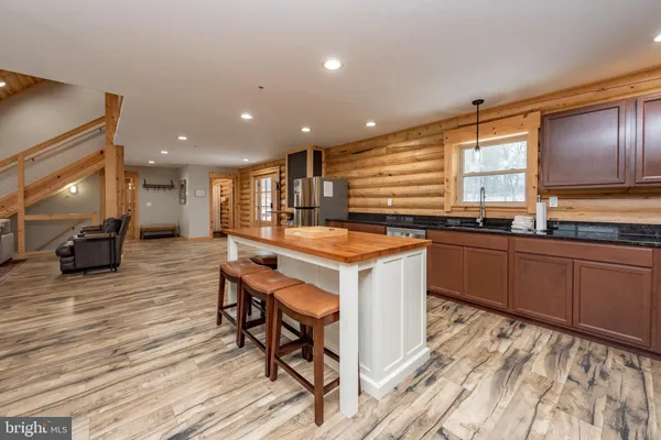 a kitchen with a sink cabinets and wooden floor