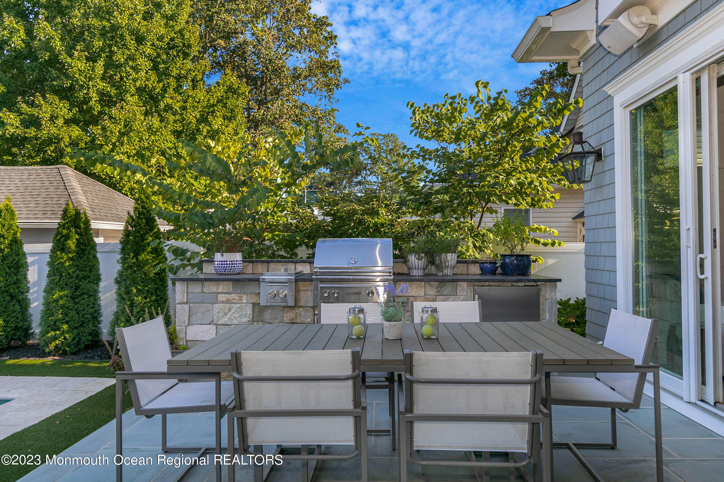 9 Allen Street Rumson, NJ 07760 - Photo 26 of 43 a view of a patio with table and chairs and potted plants