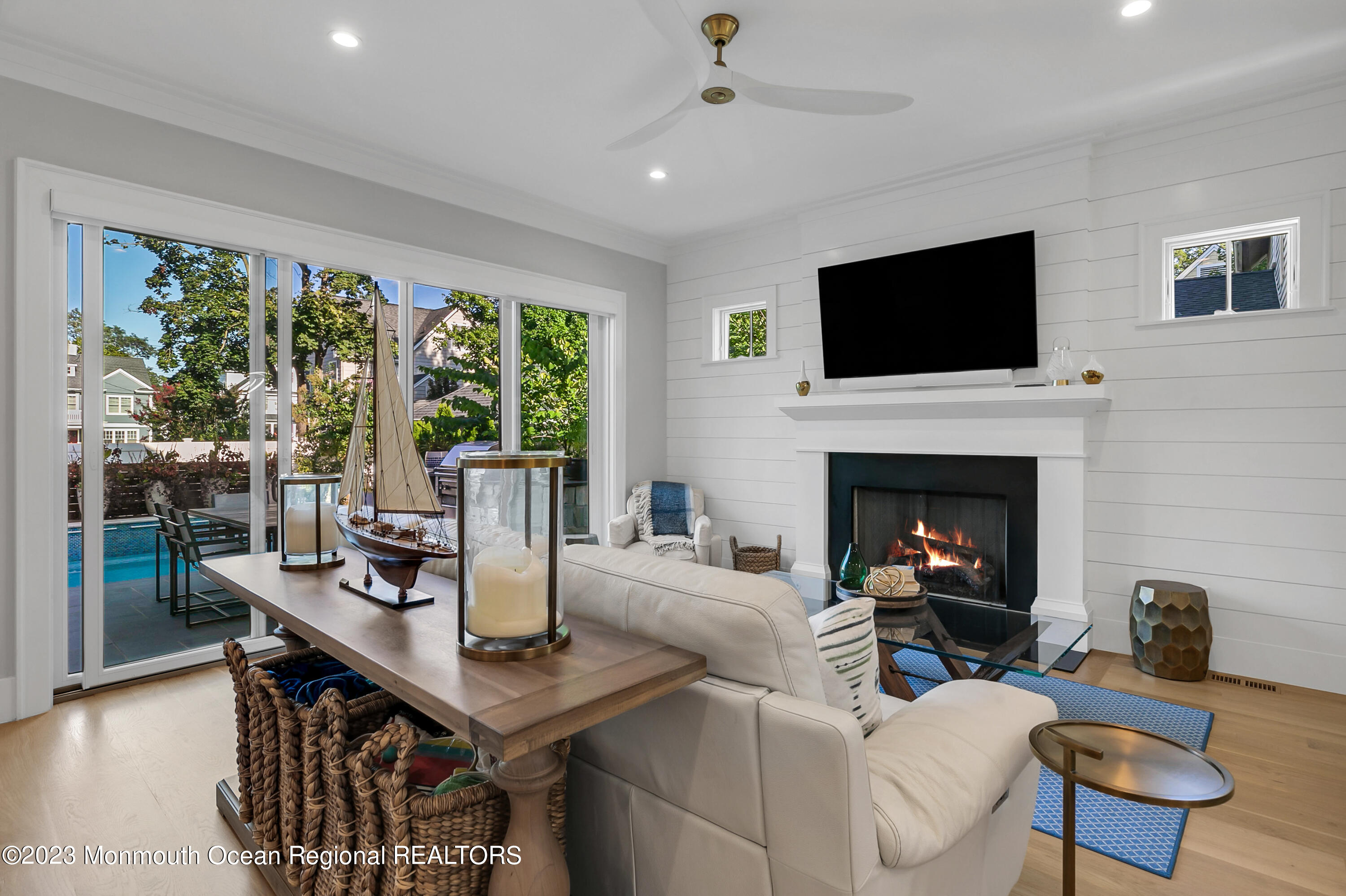 9 Allen Street Rumson, NJ 07760 - Photo 7 of 43 a living room with furniture a fireplace and a flat screen tv