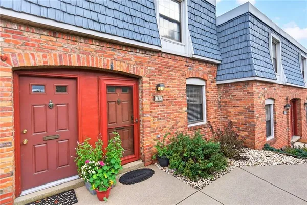 a view of a house with potted plants