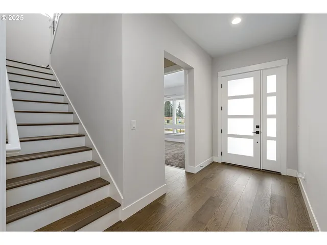 a view of an entryway with wooden floor