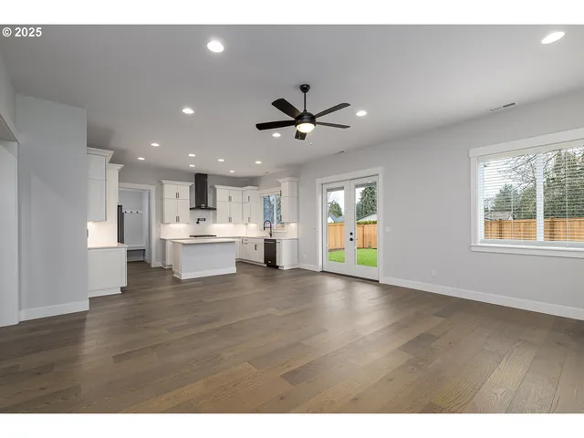 a kitchen with kitchen island white cabinets and stainless steel appliances