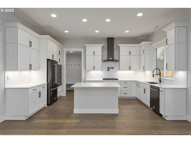 a kitchen with cabinets and appliances