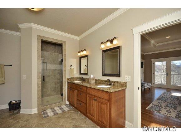 340 Porters Ridge Canton, NC 28716 - Photo 13 of 22 a bathroom with a granite countertop sink a mirror and a shower