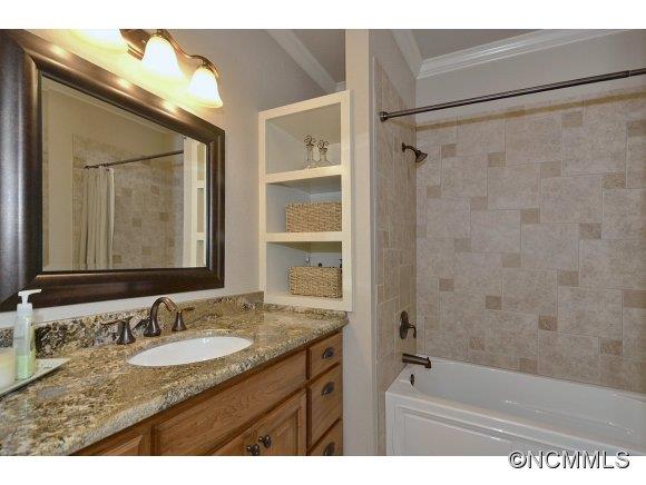 340 Porters Ridge Canton, NC 28716 - Photo 16 of 22 a bathroom with a granite countertop sink a mirror and a shower