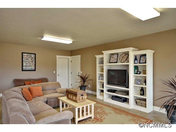 340 Porters Ridge Canton, NC 28716 - Photo 19 of 22 a living room with furniture a flat screen tv and a wall painting