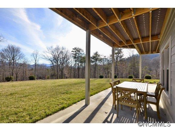340 Porters Ridge Canton, NC 28716 - Photo 21 of 22 a view of a backyard with table and chairs with wooden floor and fence