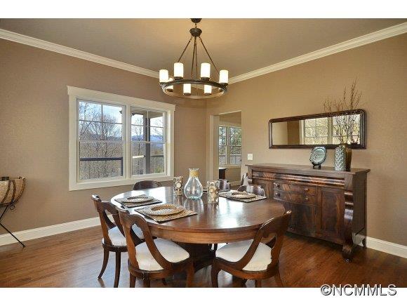 340 Porters Ridge Canton, NC 28716 - Photo 7 of 22 a dining room with wooden floor a chandelier a wooden table and chairs