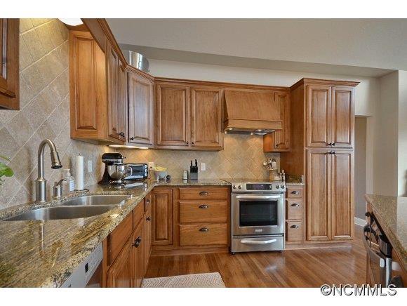 340 Porters Ridge Canton, NC 28716 - Photo 9 of 22 a kitchen with stainless steel appliances a stove a sink a refrigerator and cabinets