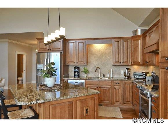 340 Porters Ridge Canton, NC 28716 - Photo 10 of 22 a kitchen with kitchen island granite countertop a sink cabinets and wooden floor