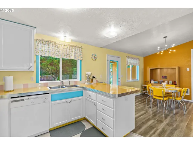 a large white kitchen with a large window