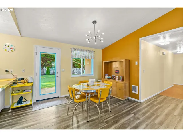 a view of a dining room with furniture and a chandelier