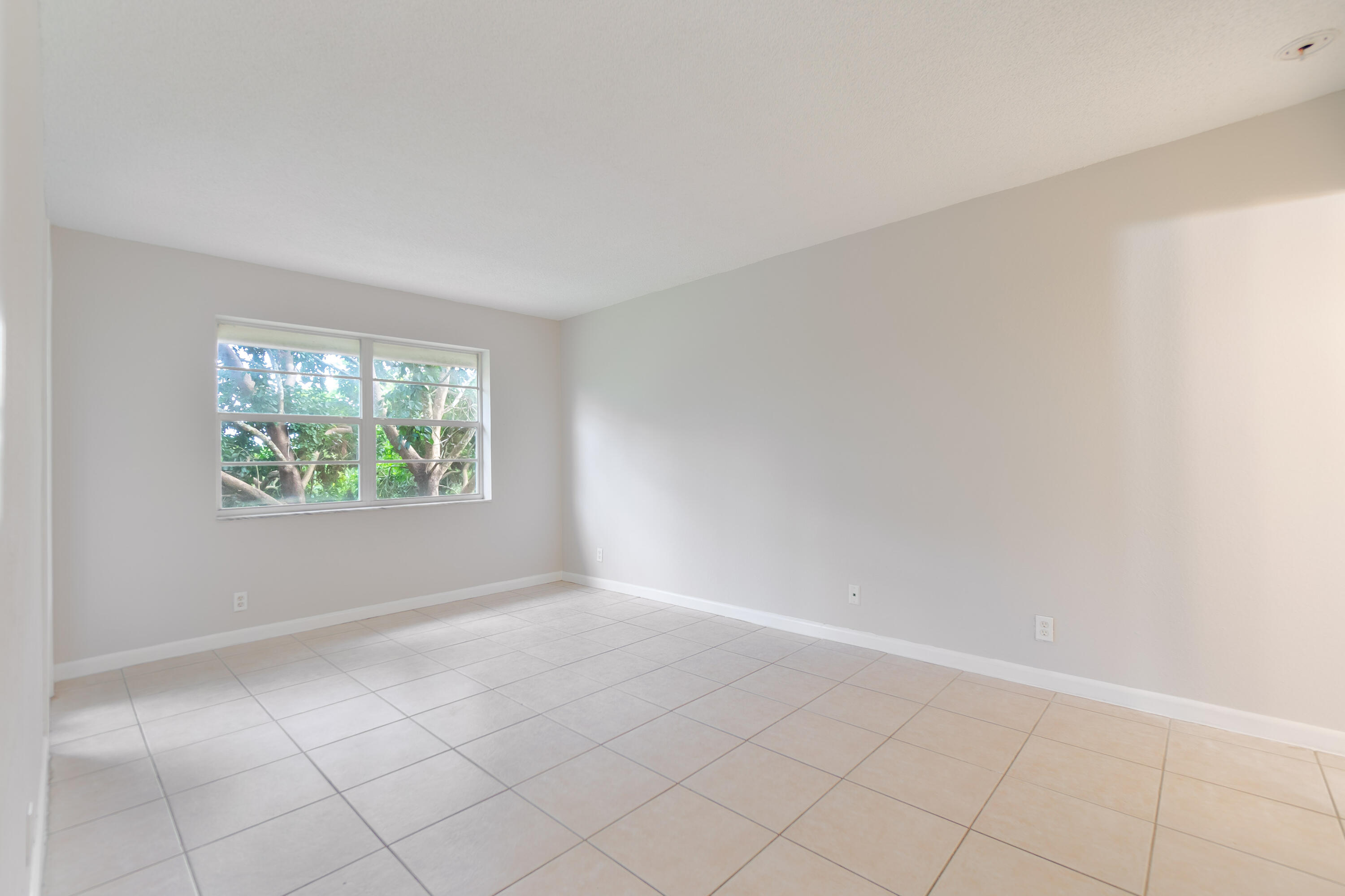 120 Sparrow Drive, Unit 314 Royal Palm Beach, FL 33411 - Photo 12 of 17 an empty room with windows