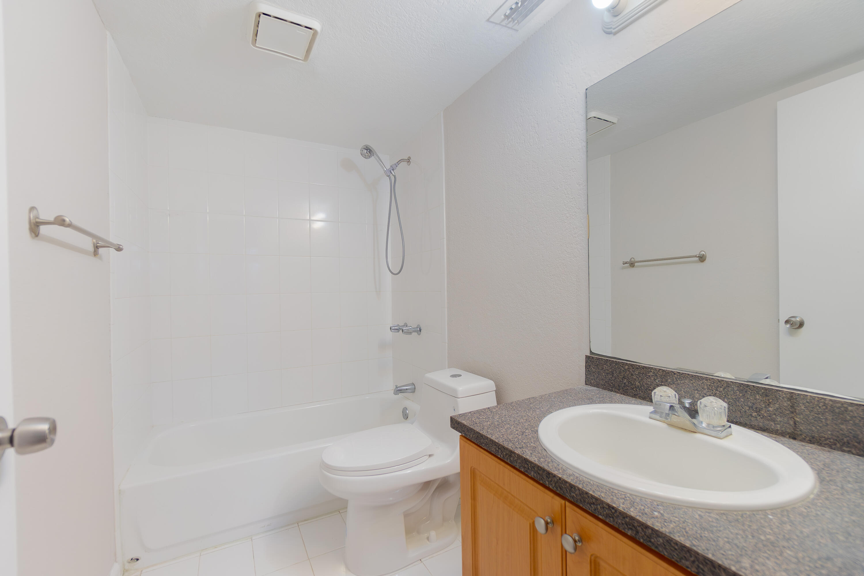 120 Sparrow Drive, Unit 314 Royal Palm Beach, FL 33411 - Photo 14 of 17 a bathroom with a granite countertop sink toilet and shower