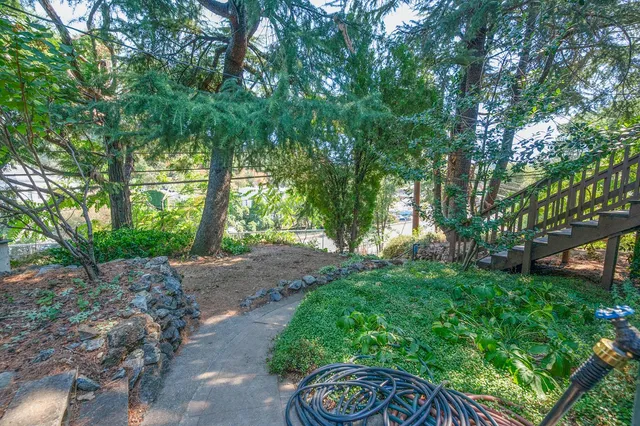 a view of a house with backyard and sitting area