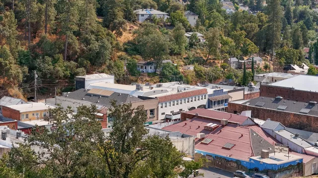 an aerial view of a houses with yard