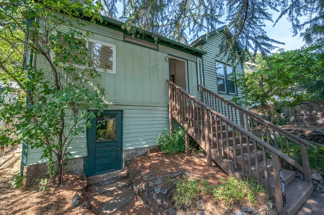 a view of a kitchen with furniture and wooden floor
