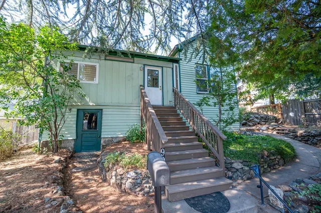 a dining room with furniture a chandelier and wooden floor