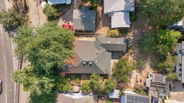 an aerial view of multiple houses with yard
