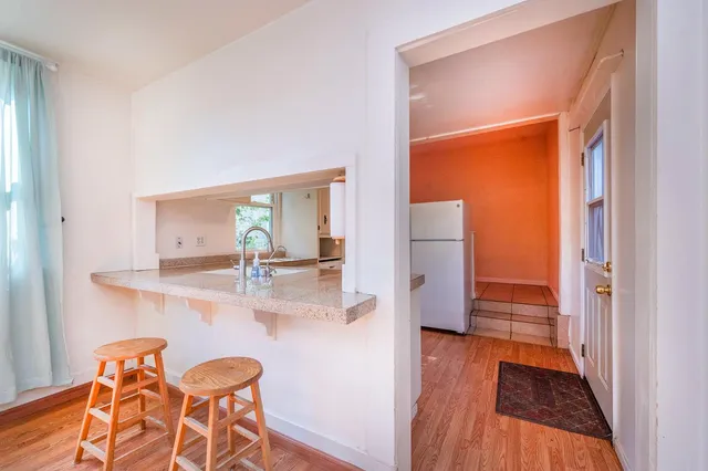 a bedroom with a bed and a potted plant