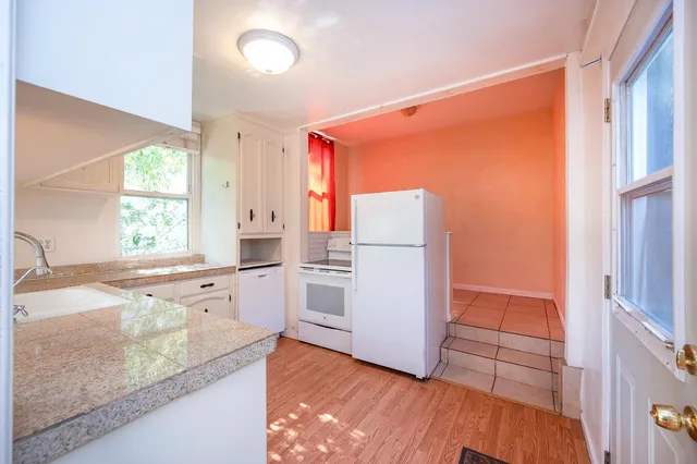 an empty room with a window and a ceiling fan