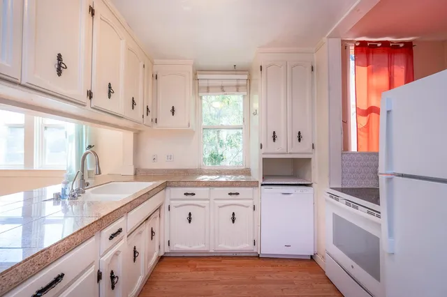 an empty room with a window and ceiling fan
