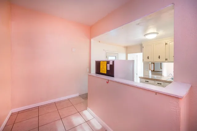 an empty room with a ceiling fan and a window