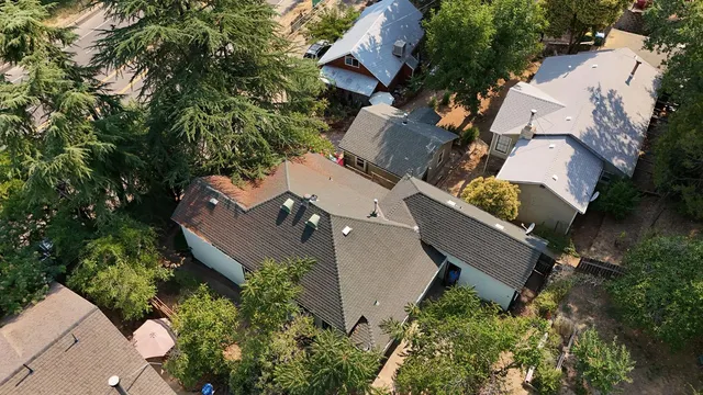 an aerial view of house with backyard