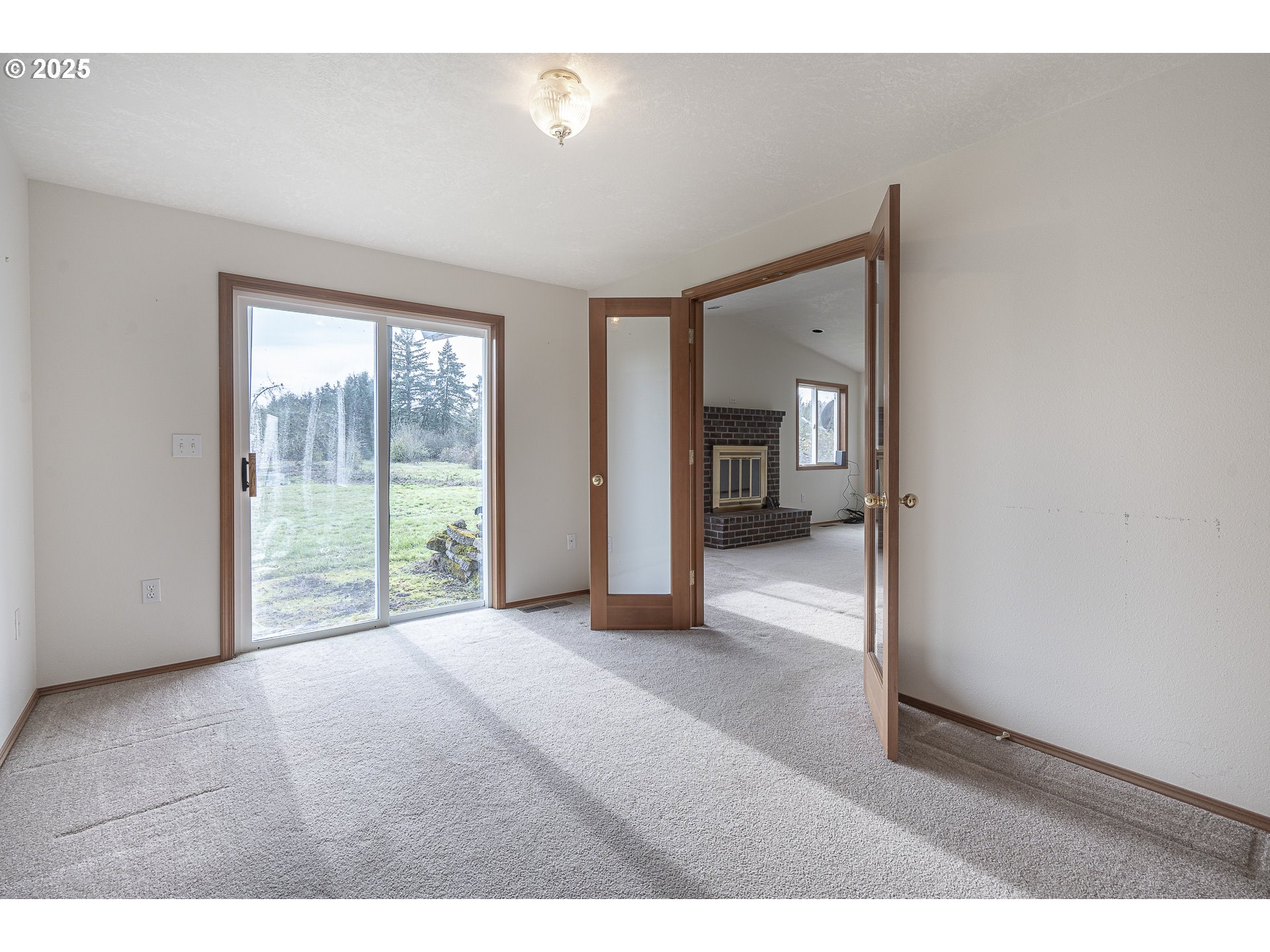 7295 Northwest Poverty Bend Road McMinnville, OR 97128 - Photo 17 of 44 a view of an empty room with glass door