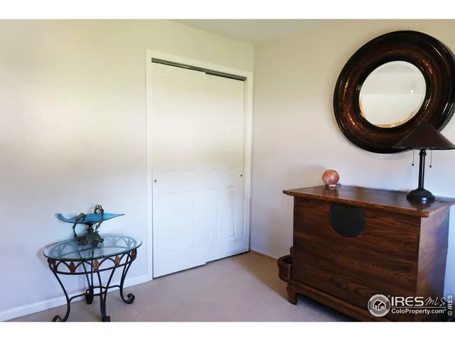 a living room with furniture and a mirror