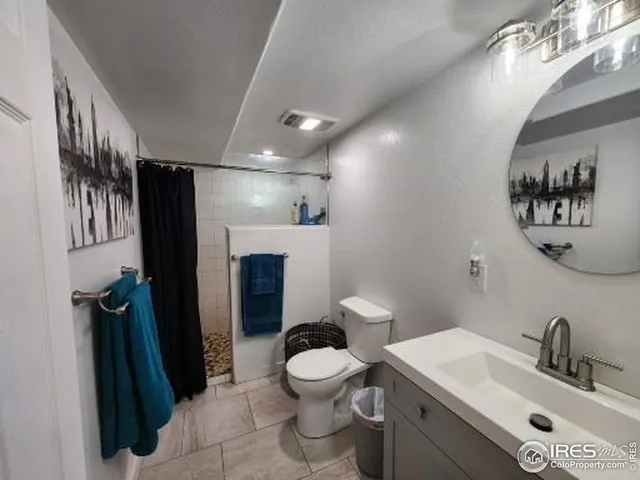 a bathroom with a toilet sink and a mirror