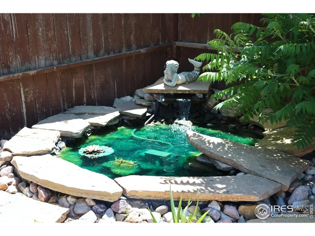 a view of a chairs and table in a backyard