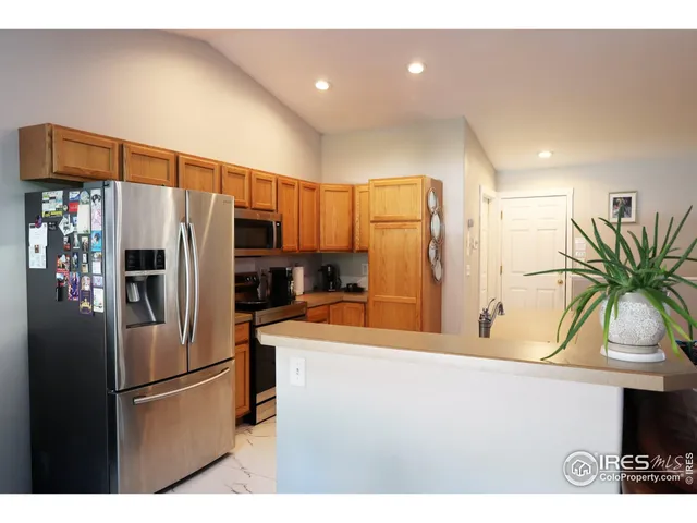 a kitchen with stainless steel appliances a refrigerator and a sink