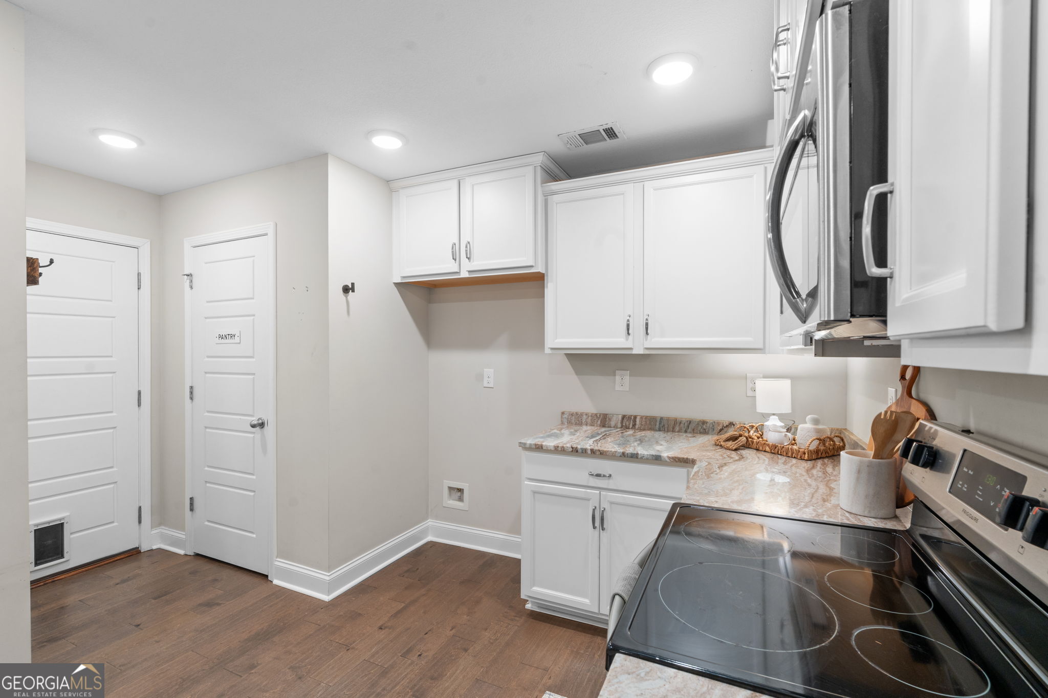 171 Hawks Rdg Trace Byron, GA 31008 - Photo 12 of 34 a kitchen with stainless steel appliances a stove microwave and cabinets