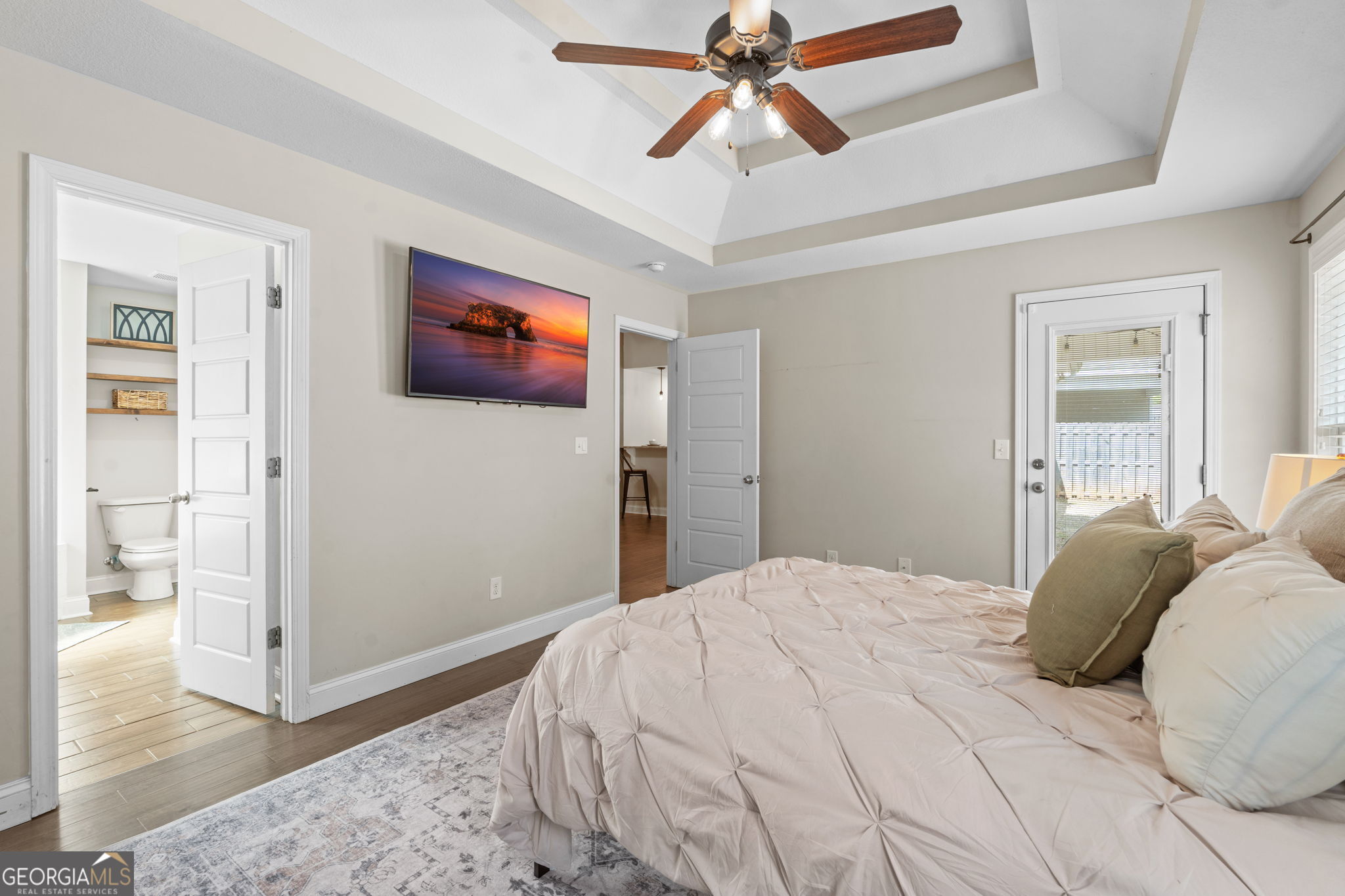 171 Hawks Rdg Trace Byron, GA 31008 - Photo 18 of 34 a bedroom with a large bed and a chandelier