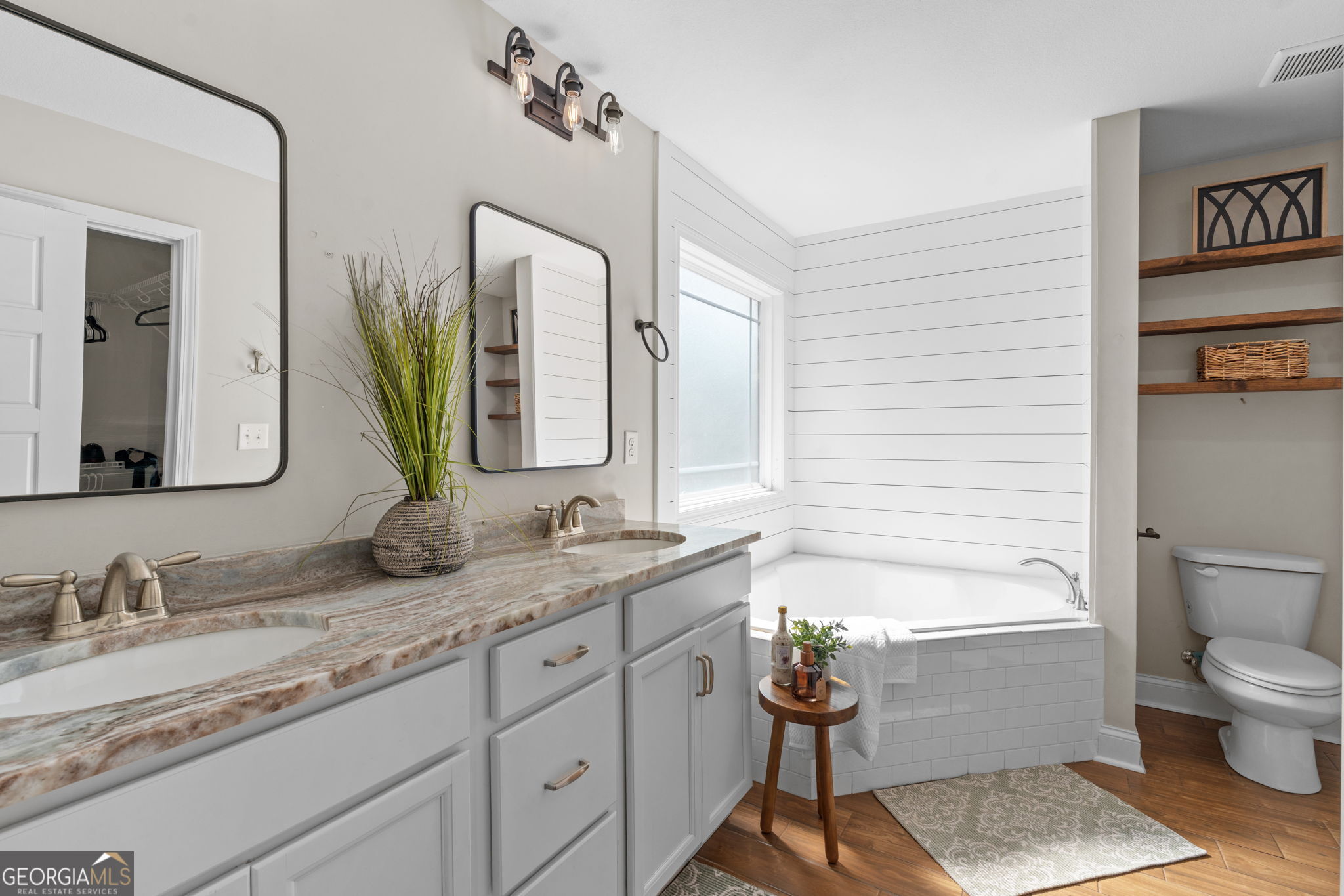 171 Hawks Rdg Trace Byron, GA 31008 - Photo 20 of 34 a bathroom with a granite countertop sink vanity mirror bathtub shower and a toilet