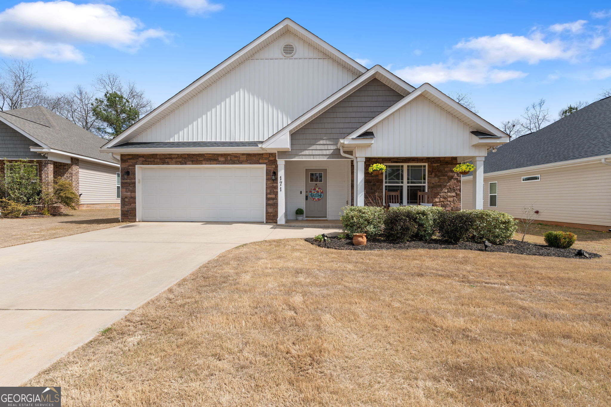 171 Hawks Rdg Trace Byron, GA 31008 - Photo 2 of 34 a front view of a house with a yard and garage