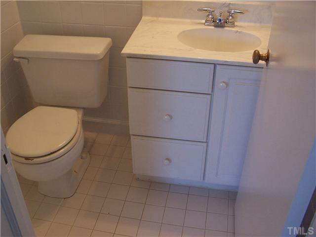 108 Lord Berkley Road Raleigh, NC 27610 - Photo 13 of 24 a bathroom with a toilet and a sink