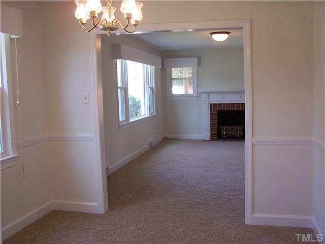 108 Lord Berkley Road Raleigh, NC 27610 - Photo 5 of 24 en empty room with windows and fireplace