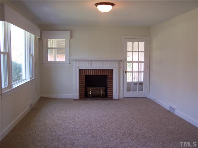 108 Lord Berkley Road Raleigh, NC 27610 - Photo 6 of 24 an empty room with windows and fireplace