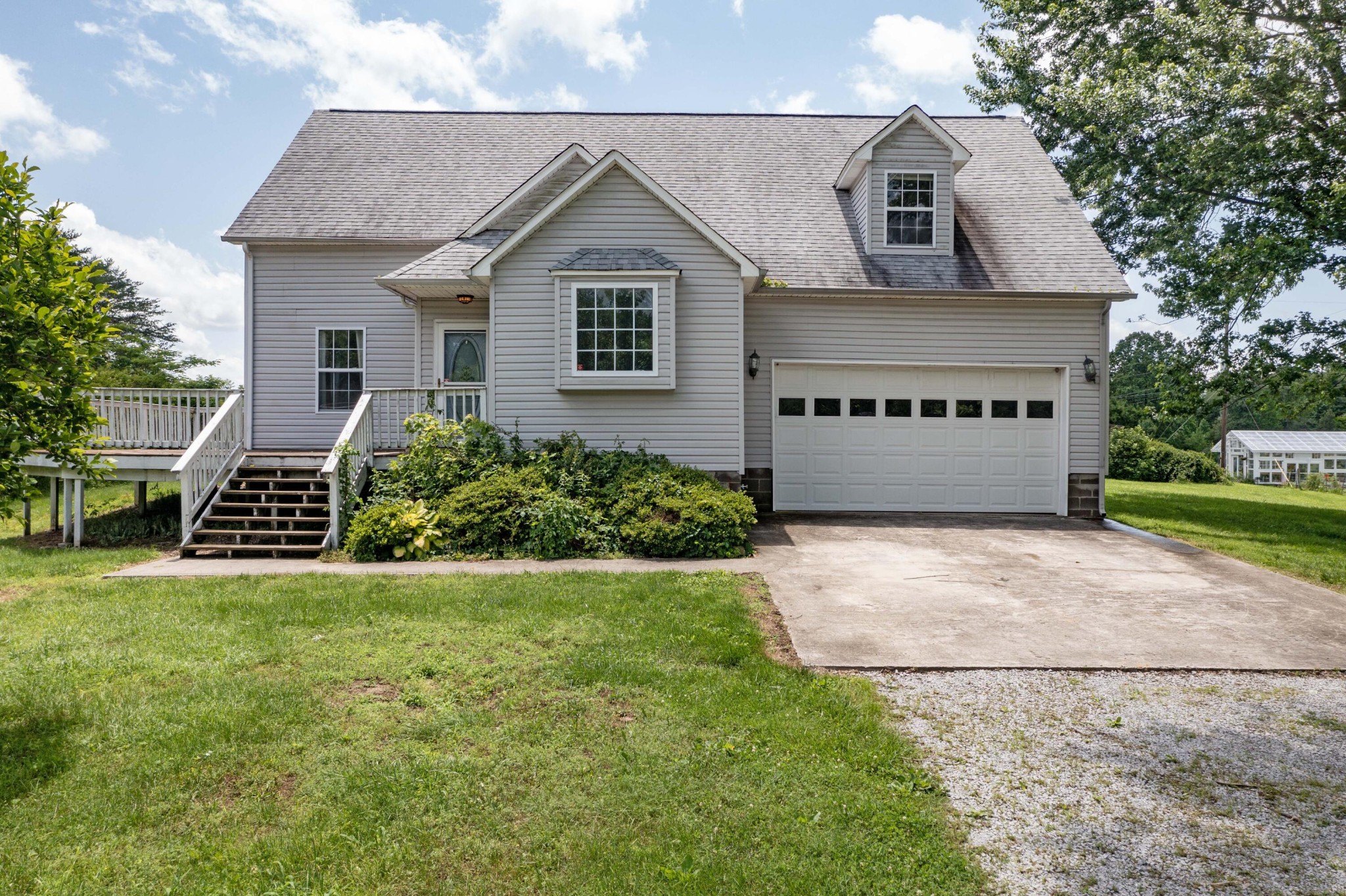 1165 Possum Trot Road Grandview, TN 37337 - Photo 1 of 48 a front view of a house with a yard and garage