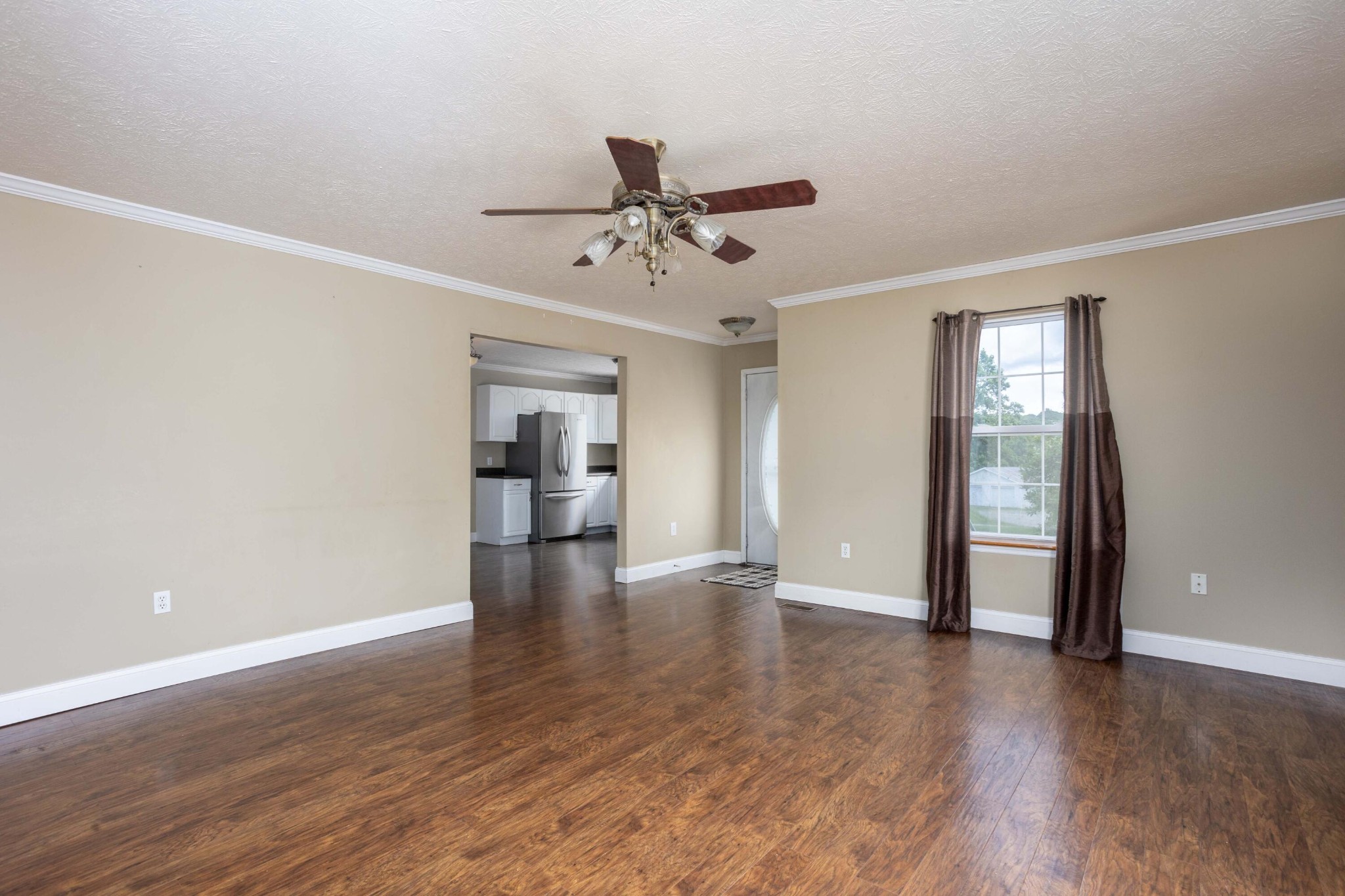 1165 Possum Trot Road Grandview, TN 37337 - Photo 12 of 48 a view of an empty room with window and wooden floor