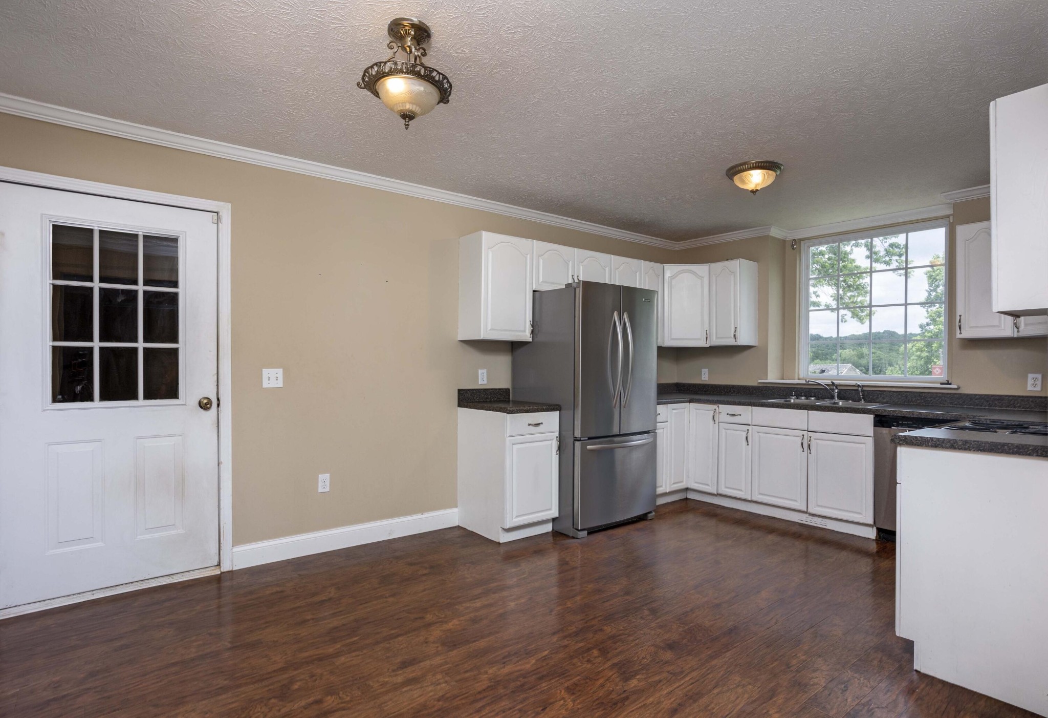 1165 Possum Trot Road Grandview, TN 37337 - Photo 14 of 48 a kitchen with a refrigerator and a stove top oven