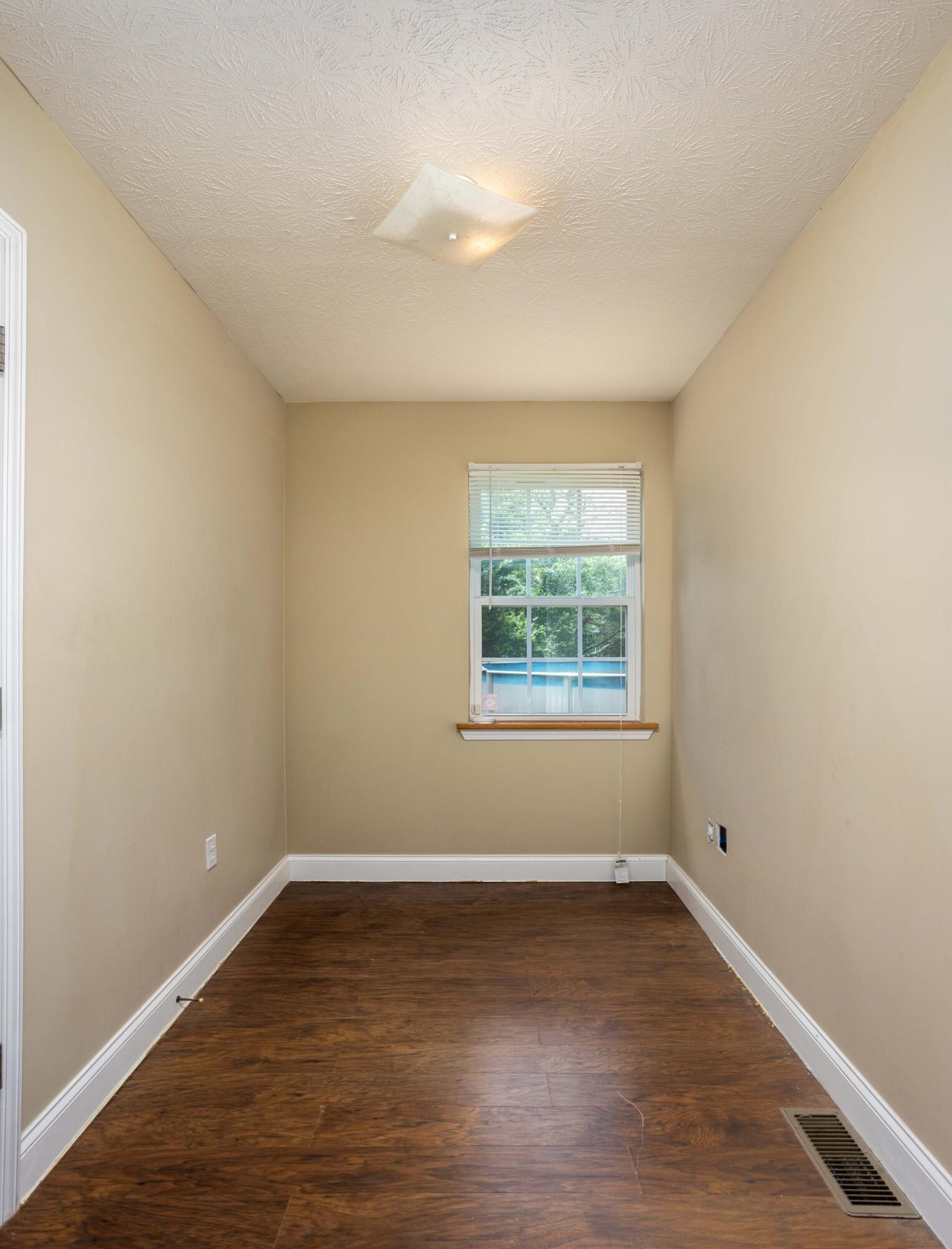 1165 Possum Trot Road Grandview, TN 37337 - Photo 32 of 48 an empty room with wooden floor and windows