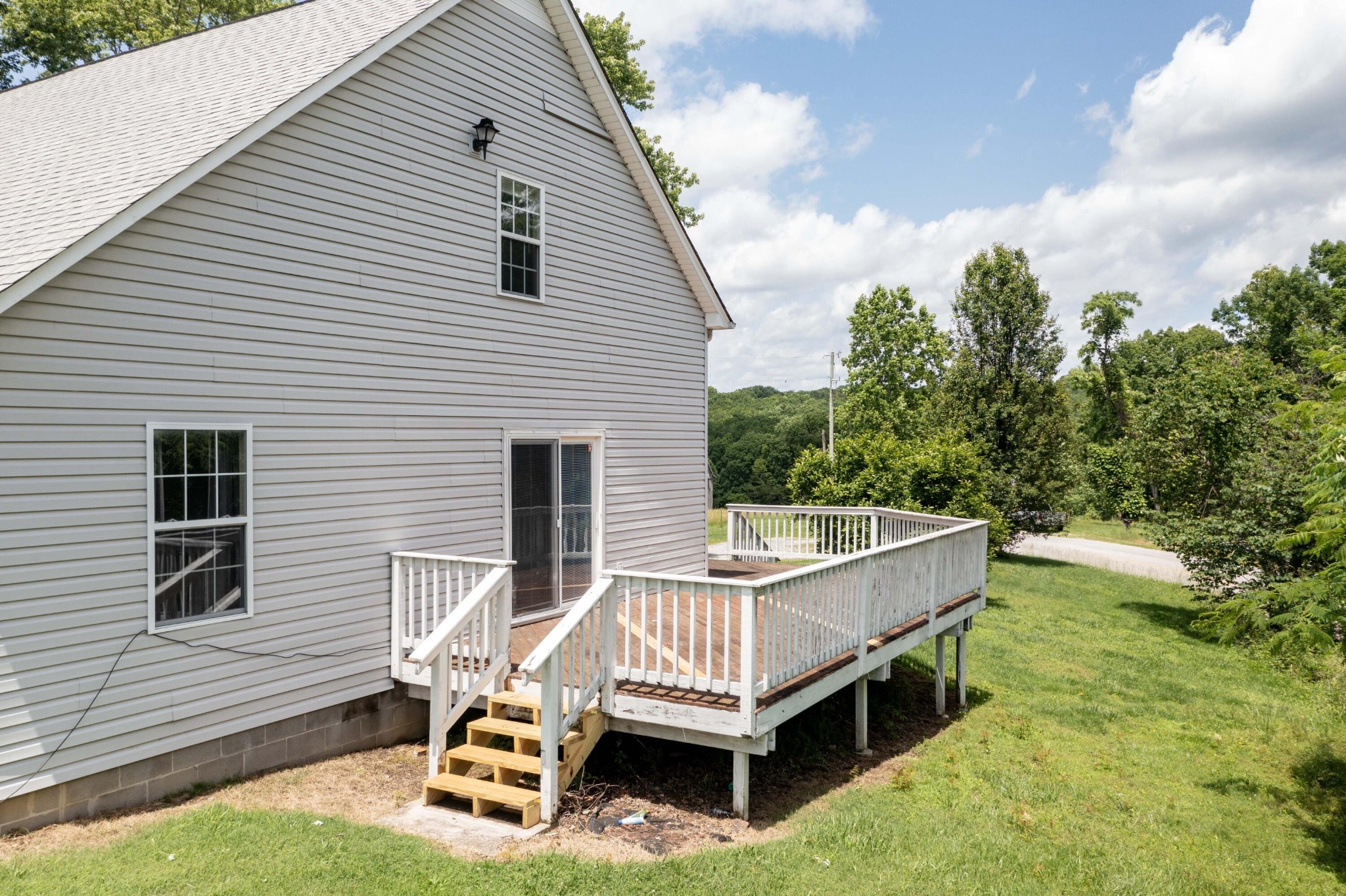 1165 Possum Trot Road Grandview, TN 37337 - Photo 44 of 48 a view of a wooden deck and a yard