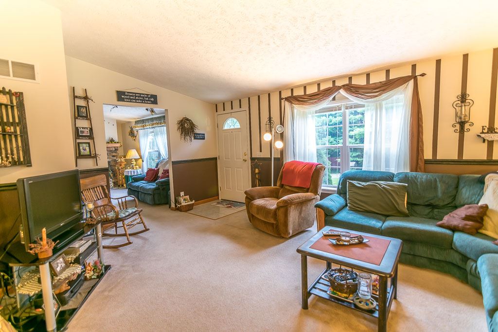 325 Steeles Fort Road Raphine, VA 24472 - Photo 20 of 50 a living room with furniture a window and a flat screen tv