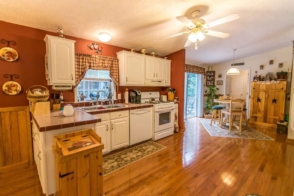 325 Steeles Fort Road Raphine, VA 24472 - Photo 26 of 50 a kitchen with stainless steel appliances granite countertop a refrigerator a stove and a wooden floors