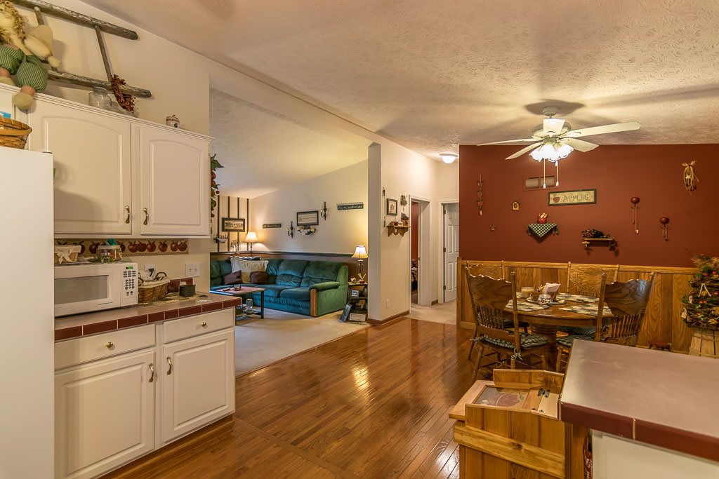 325 Steeles Fort Road Raphine, VA 24472 - Photo 35 of 50 a kitchen with stainless steel appliances kitchen island granite countertop a stove a sink and white cabinets with wooden floor